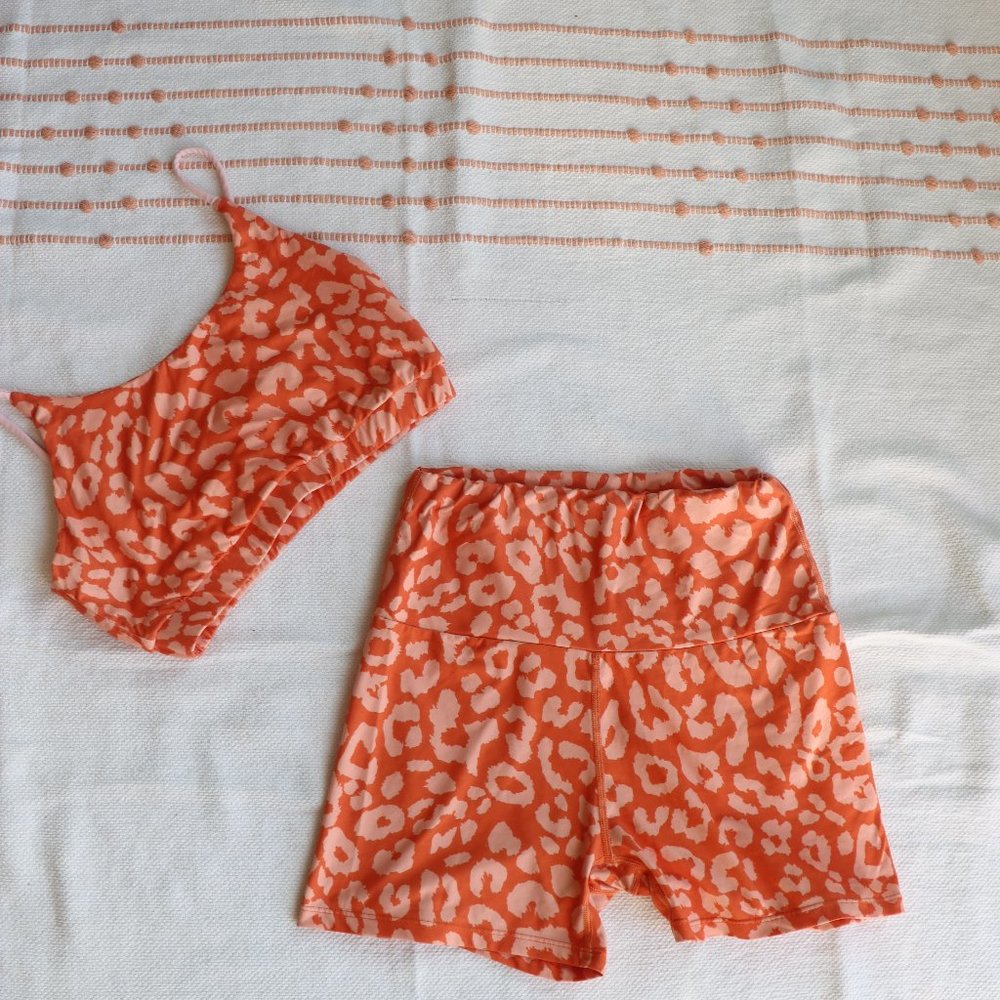 Orange leopard print biker shorts and sports bra